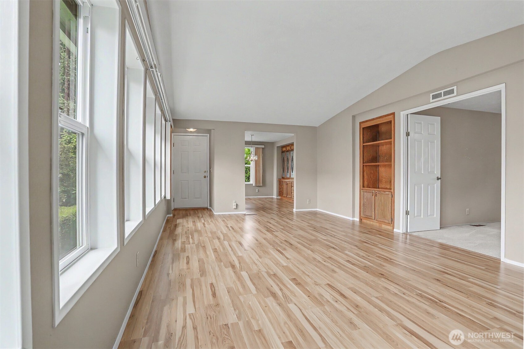 905 243rd Street Southwest Bothell, WA 98021 - Photo 12 of 37 a view of an empty room with wooden floor and a window