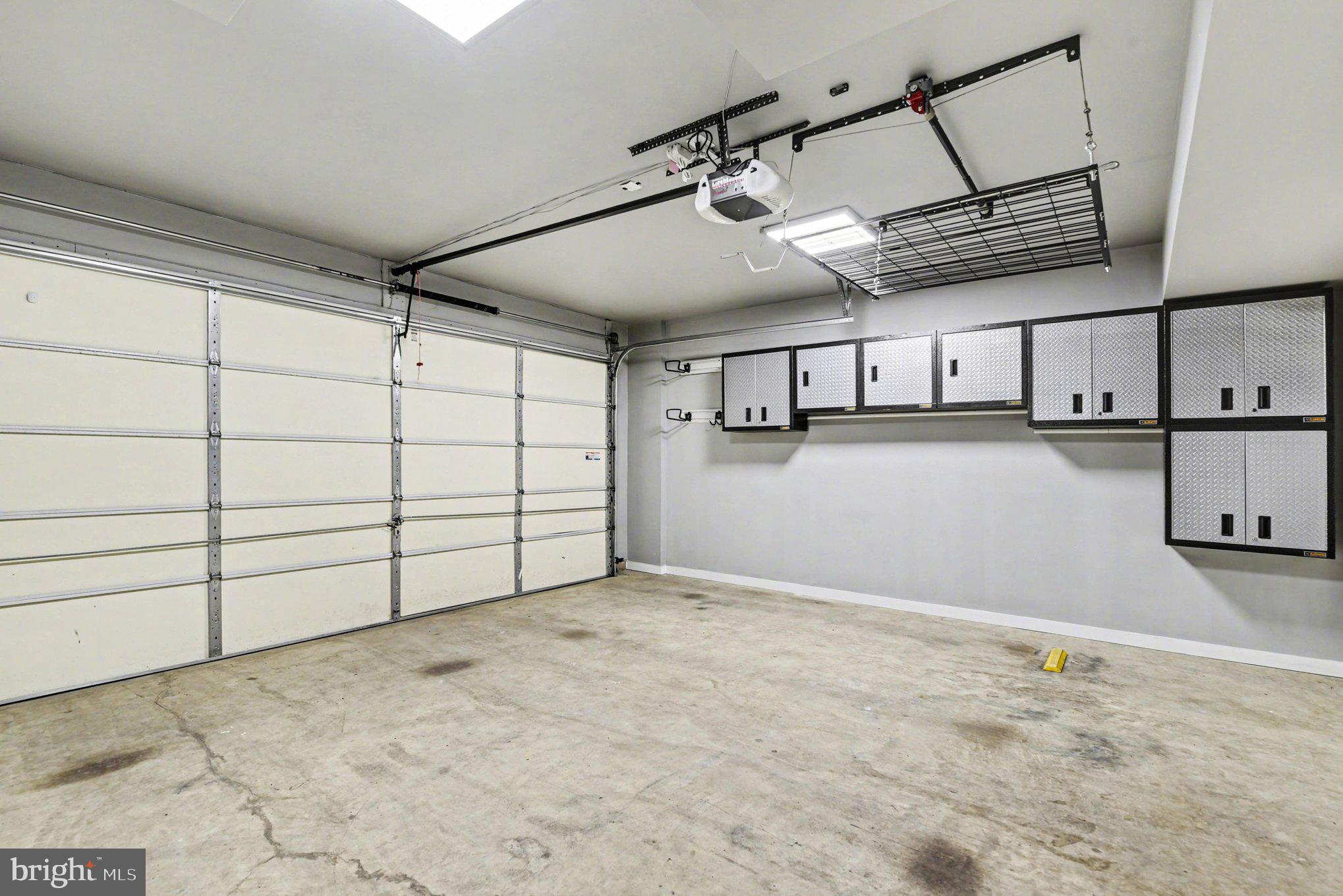 5954 Logans Way Ellicott City, MD 21043 - Photo 35 of 46 2 car garage with cabinets, opener & storage lift