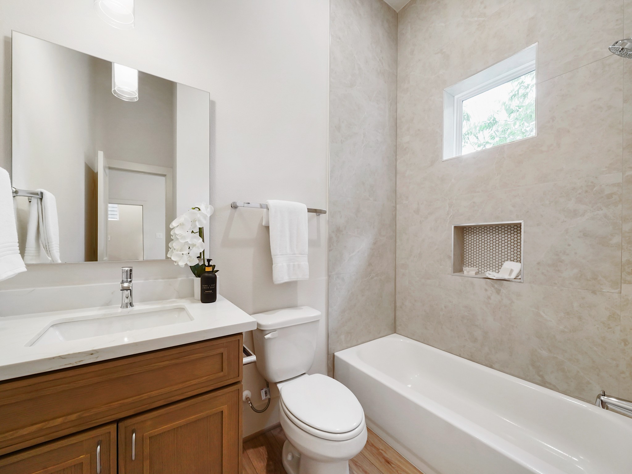 861 Rachel Street, Unit E Houston, TX 77091 - Photo 22 of 29 Discover a stylish second bathroom featuring sleek fixtures, a chic vanity, and a bright, inviting atmosphere perfect for guests or family.