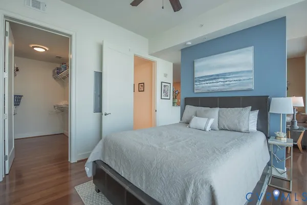 a bedroom with a bed and wooden floor
