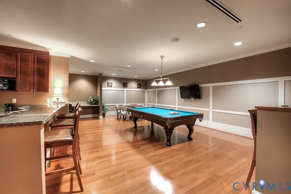 a room with lots of furniture and view of gym equipment