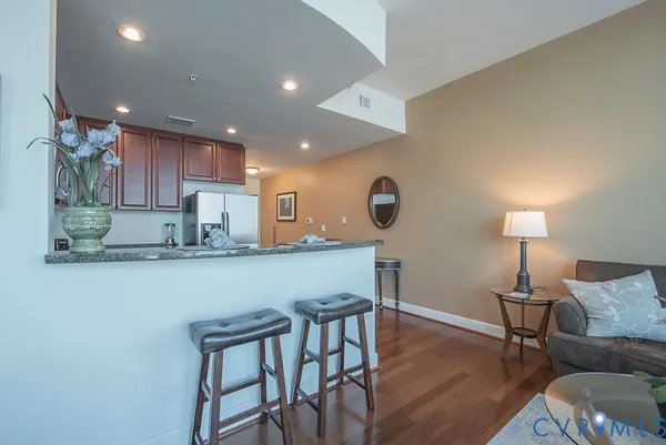 a kitchen with a table chairs refrigerator and microwave