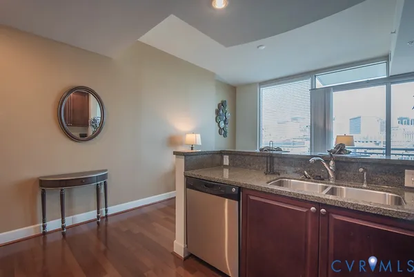 a kitchen with a sink cabinets and a wooden floor
