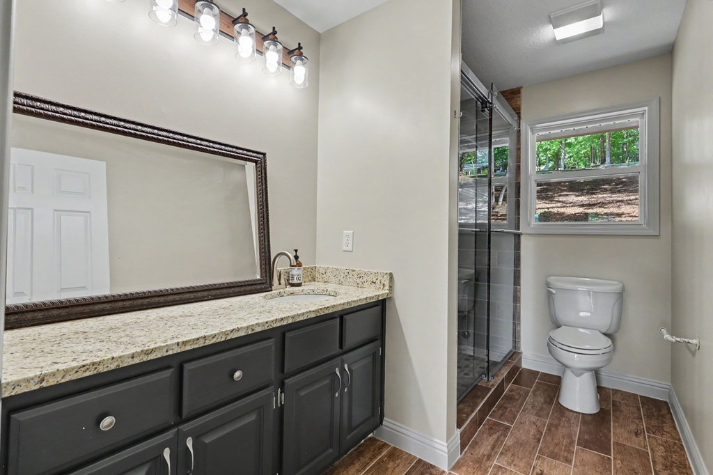 456 Deaver Cove Road Blairsville, GA 30512 - Photo 21 of 83 a spacious bathroom with a granite countertop sink toilet and mirror