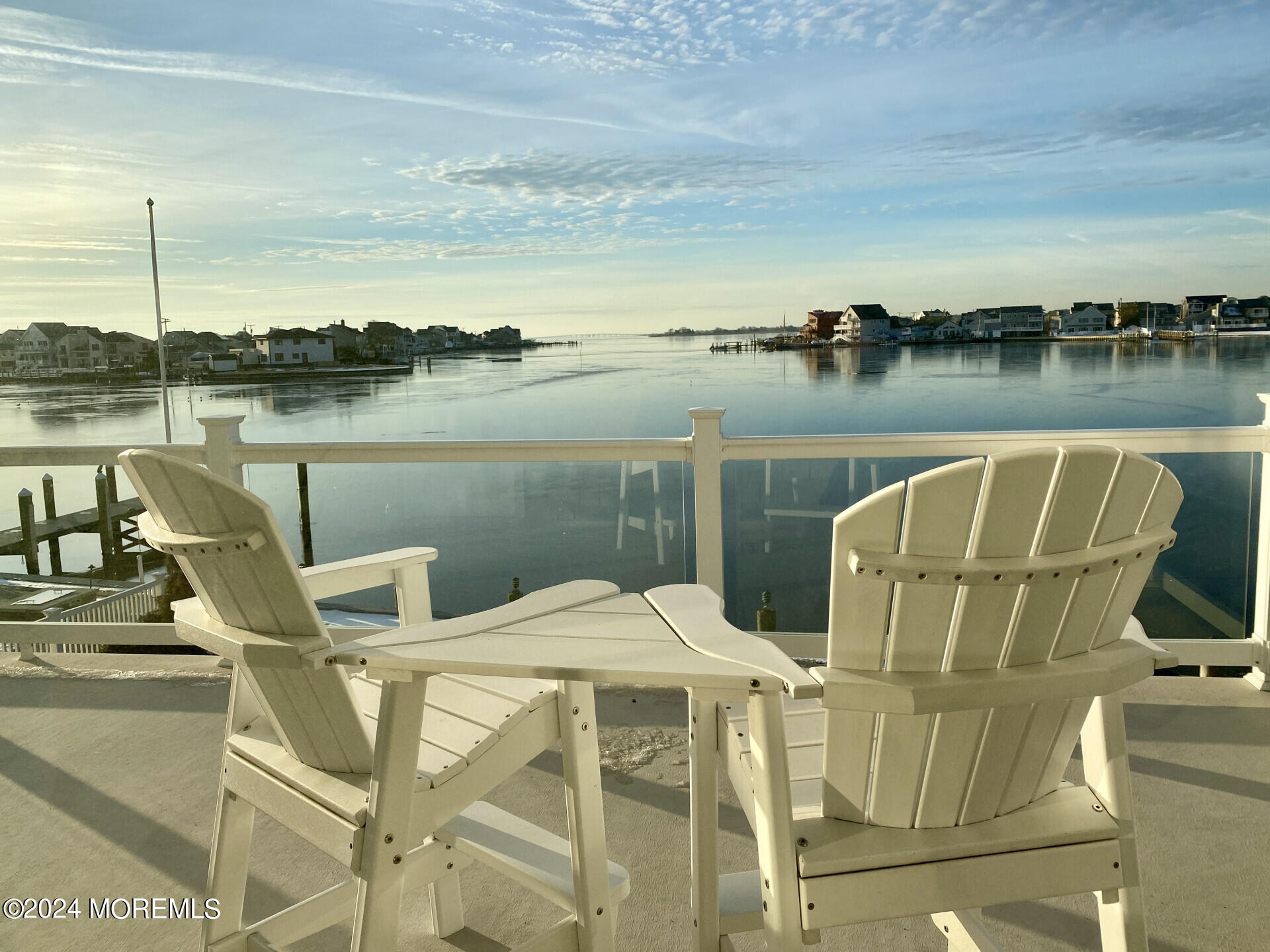 4 Neptune Road Toms River, NJ 08753 - Photo 4 of 24 a view of a lake with couches chairs and city view