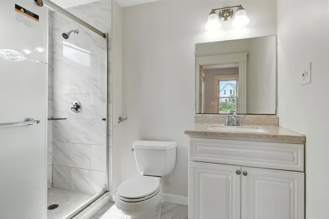 a bathroom with a toilet a sink and shower