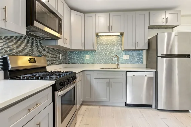 a kitchen with a stove microwave and refrigerator