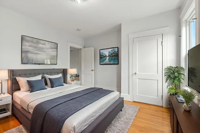 a bedroom with a bed and a potted plant