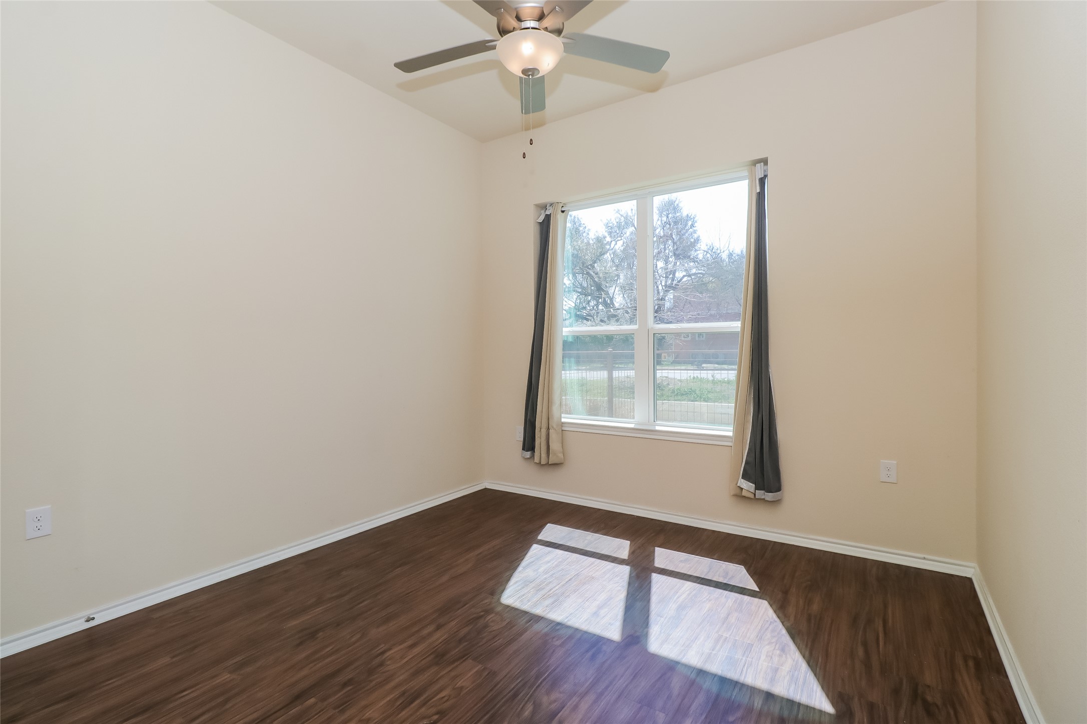 8601 West Gate Boulevard, Unit 7101 Austin, TX 78745 - Photo 10 of 16 Spare room with dark wood-style floors and ceiling fan