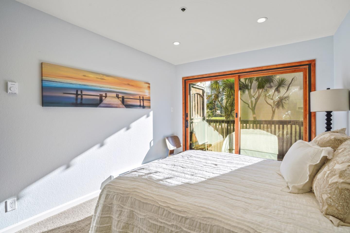207 Monterey Road, Unit 3 Pacifica, CA 94044 - Photo 20 of 43 a bedroom with a large bed and a large window
