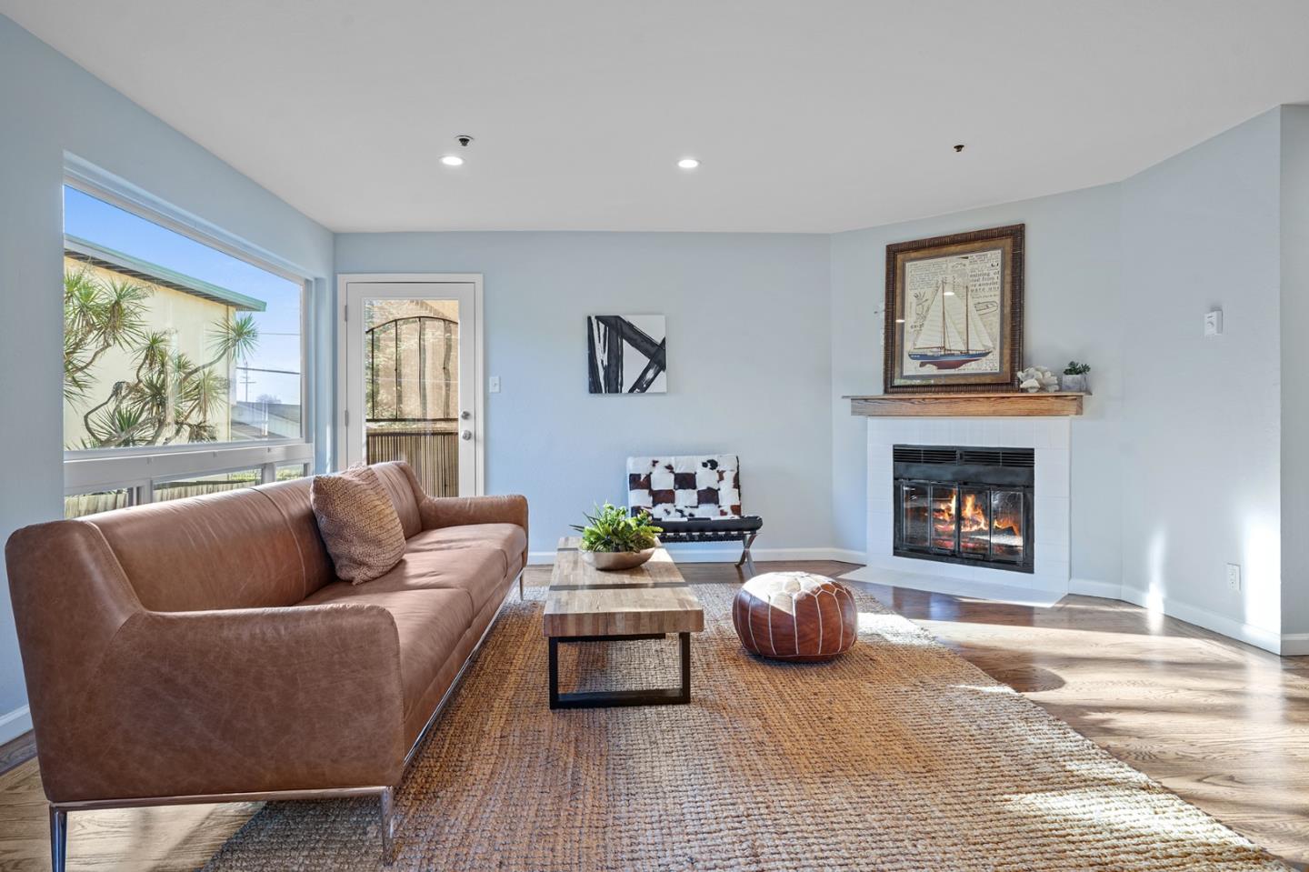 207 Monterey Road, Unit 3 Pacifica, CA 94044 - Photo 6 of 43 a living room with furniture and a fireplace