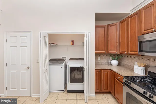 a kitchen with stainless steel appliances granite countertop a stove and a refrigerator