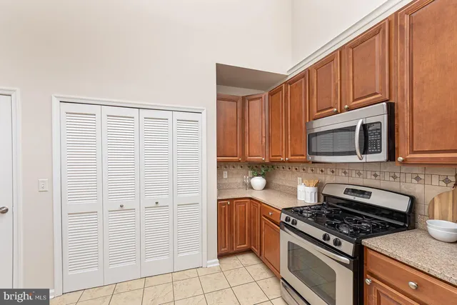 a kitchen with stainless steel appliances granite countertop a stove and a microwave