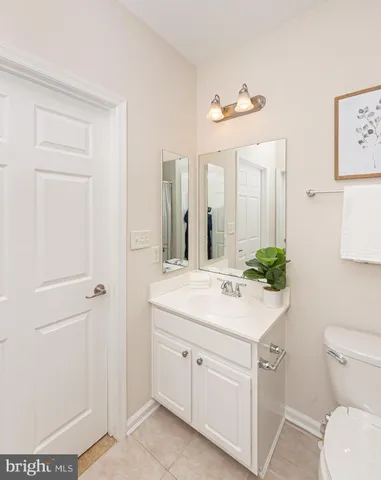a bathroom with a sink a toilet and mirror
