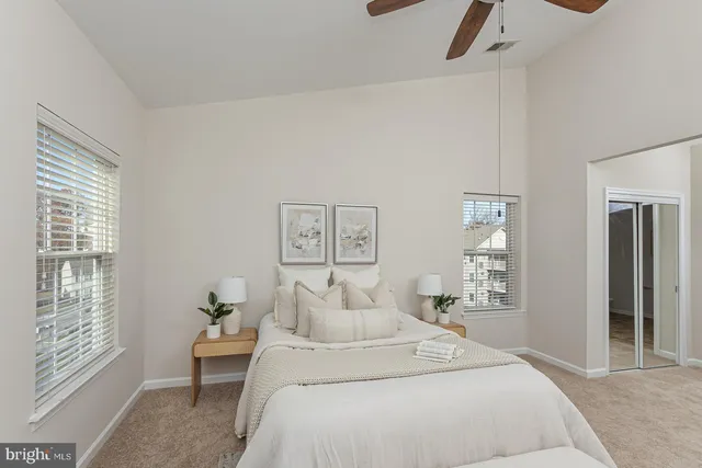 a spacious bedroom with a bed and wooden floor