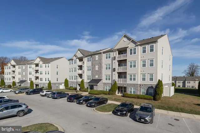 a city street lined with parked cars and buildings