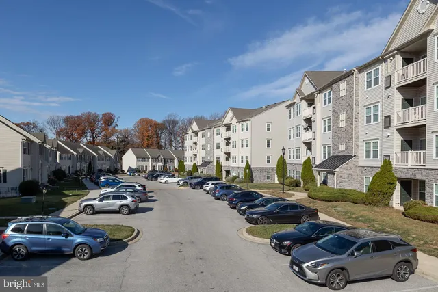 a city street lined with parked cars and buildings