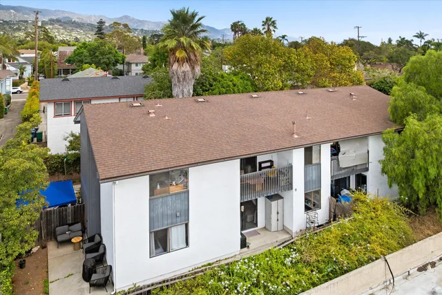 an aerial view of a house with a yard and potted plants