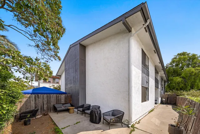 a view of a house with a yard and furniture