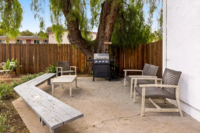 a view of a chairs and table in a backyard