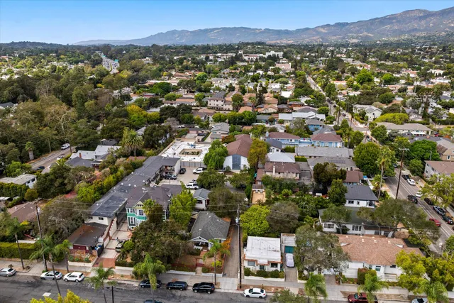 an aerial view of residential houses with outdoor space