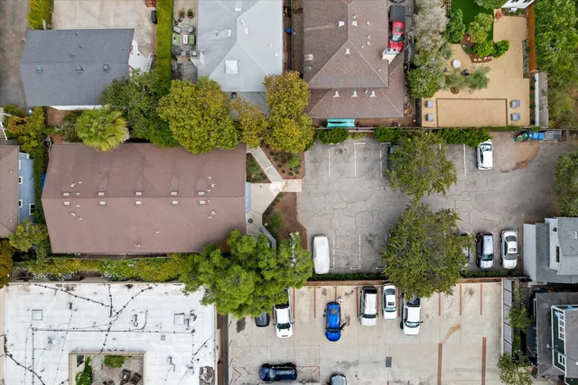 an aerial view of a house with a yard and pool