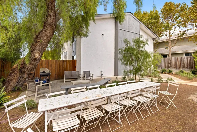 a view of a chairs and table in patio