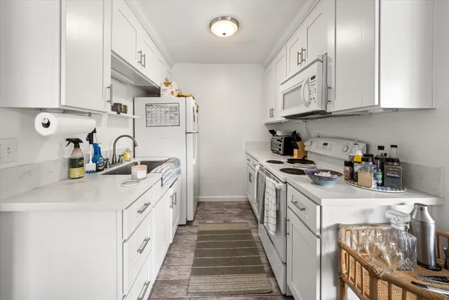 a kitchen with stainless steel appliances granite countertop a sink stove and cabinets