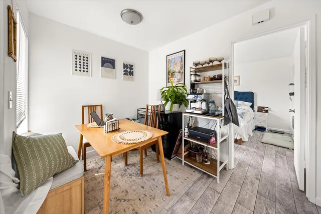 a view of a workspace with furniture and wooden floor