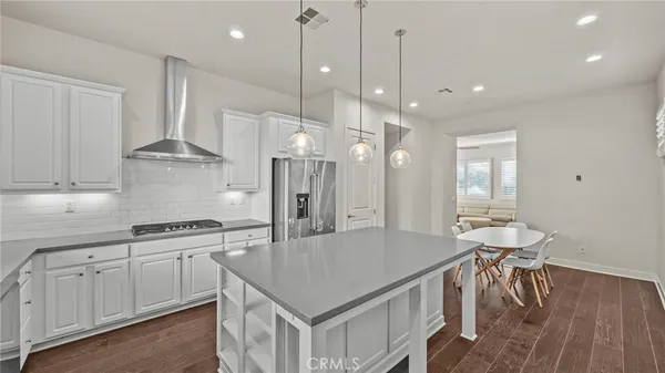 a kitchen with stainless steel appliances granite countertop a stove a sink refrigerator and a wooden cabinets