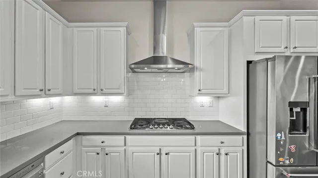 a kitchen with granite countertop a sink stove and refrigerator