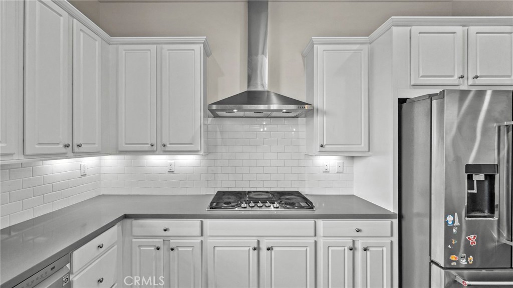 113 Carmine Irvine, CA 92618 - Photo 14 of 43 a kitchen with granite countertop a sink stove and refrigerator