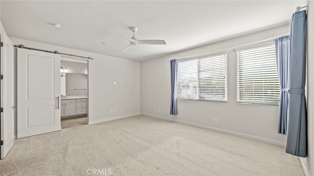 113 Carmine Irvine, CA 92618 - Photo 17 of 43 a view of an empty room with a window and a kitchen