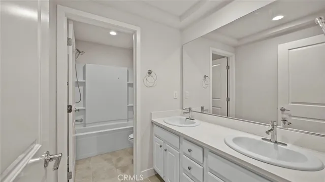 a bathroom with a double vanity sink mirror and double