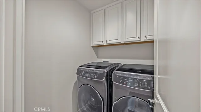 a view of storage and utility room with washer and dryer