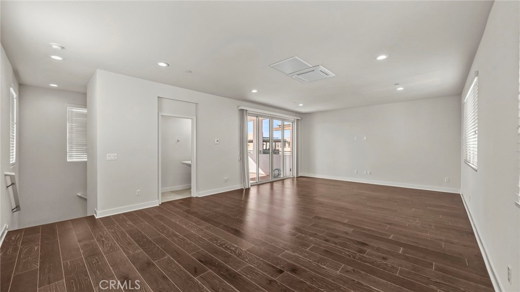 113 Carmine Irvine, CA 92618 - Photo 27 of 43 a view of an empty room with wooden floor and windows