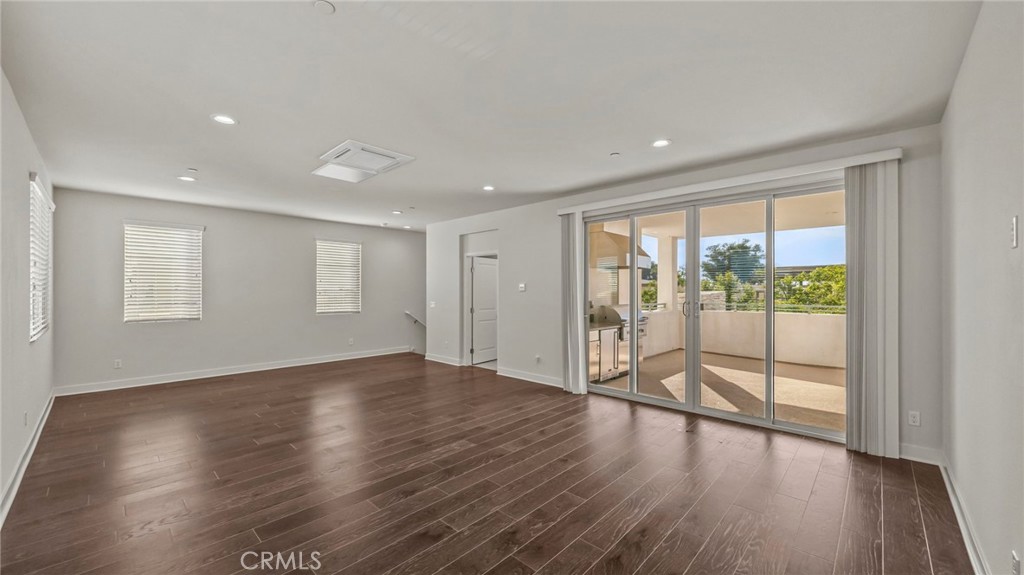 113 Carmine Irvine, CA 92618 - Photo 28 of 43 a view of an empty room with wooden floor and a window