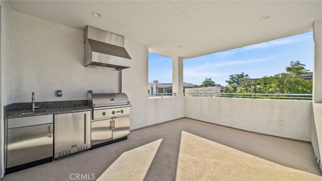 113 Carmine Irvine, CA 92618 - Photo 31 of 43 a kitchen with stainless steel appliances granite countertop a stove a sink and a microwave