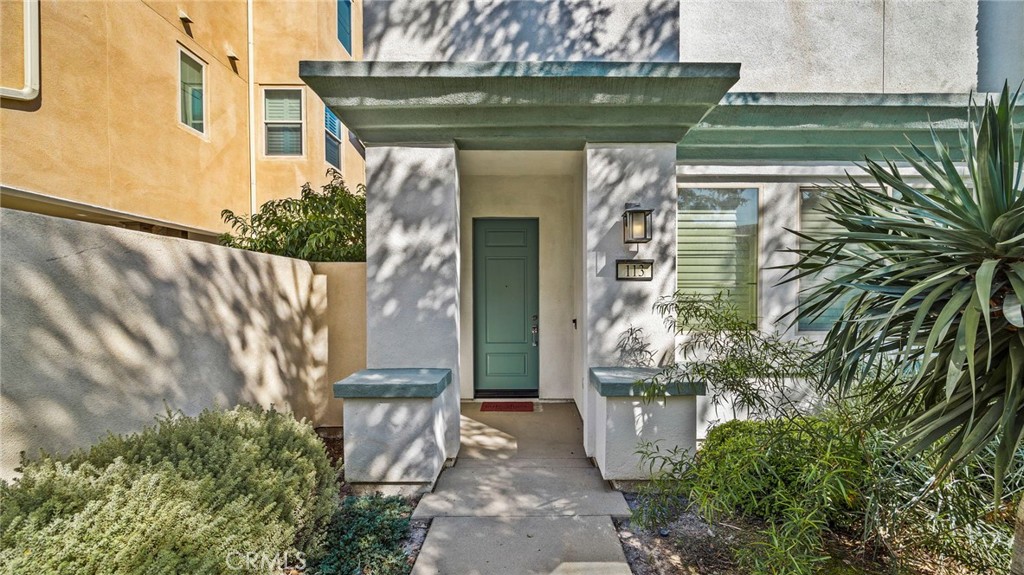 113 Carmine Irvine, CA 92618 - Photo 4 of 43 a front view of a house with a garden