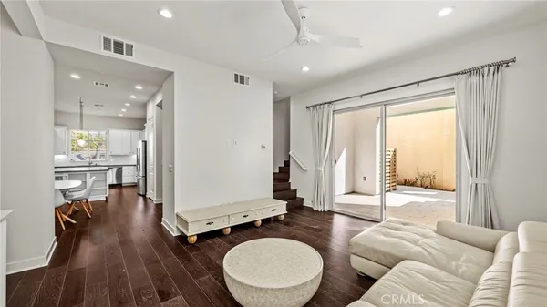 a living room with furniture a large window with wooden floor