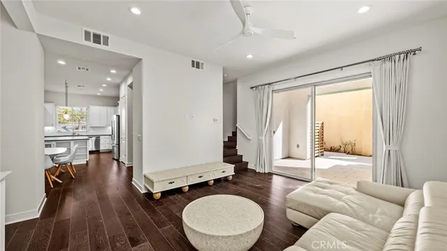 a living room with furniture a large window with wooden floor