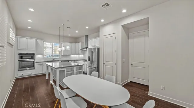 a kitchen with kitchen island a sink stove and refrigerator