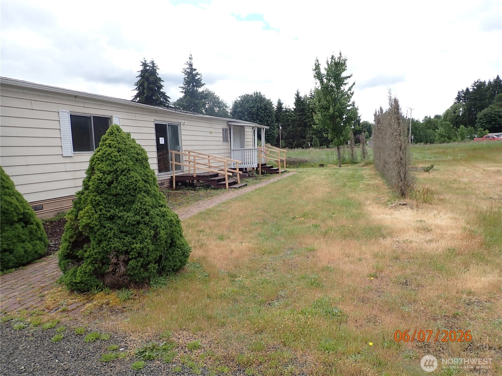 9217 183rd Avenue Southwest Rochester, WA 98579 - Photo 1 of 26 a view of a house with backyard and trees
