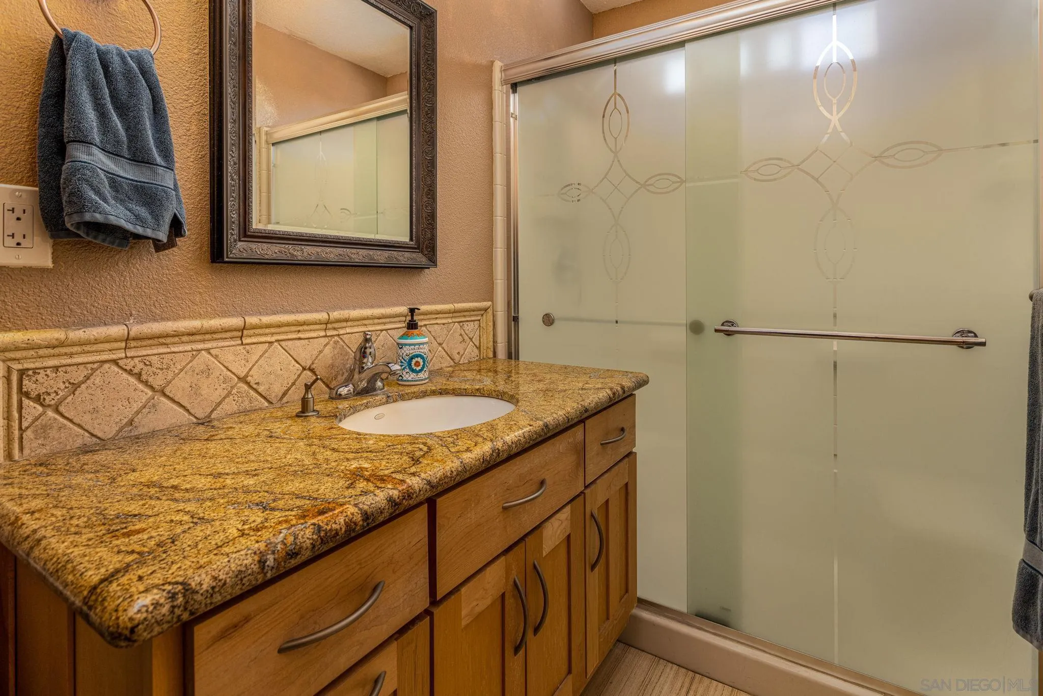 532 Kempton Street Spring Valley, CA 91977 - Photo 23 of 30 a bathroom with a granite countertop sink and a mirror