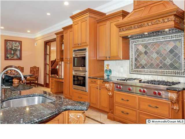 34 Line Road Holmdel, NJ 07733 - Photo 11 of 25 a kitchen with stainless steel appliances granite countertop a sink a stove and a refrigerator