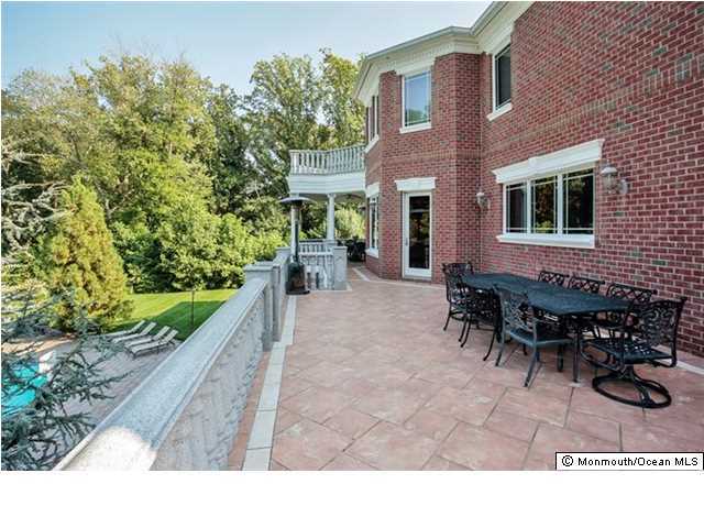 34 Line Road Holmdel, NJ 07733 - Photo 12 of 25 a backyard of a house with yard and outdoor seating