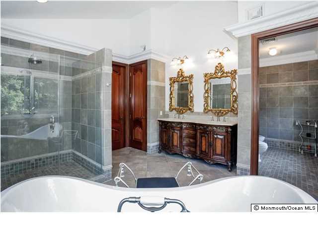 34 Line Road Holmdel, NJ 07733 - Photo 16 of 25 a bathroom with a tub sink and double vanity