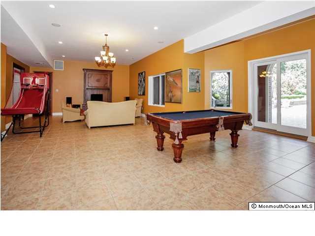34 Line Road Holmdel, NJ 07733 - Photo 19 of 25 a living room with furniture a chandelier and a pool table