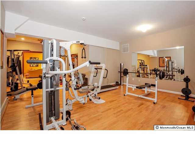 34 Line Road Holmdel, NJ 07733 - Photo 20 of 25 a living room with lots of gym equipment