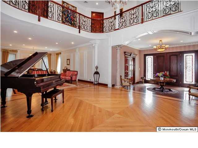 34 Line Road Holmdel, NJ 07733 - Photo 3 of 25 a living room with furniture pool table and a chandelier